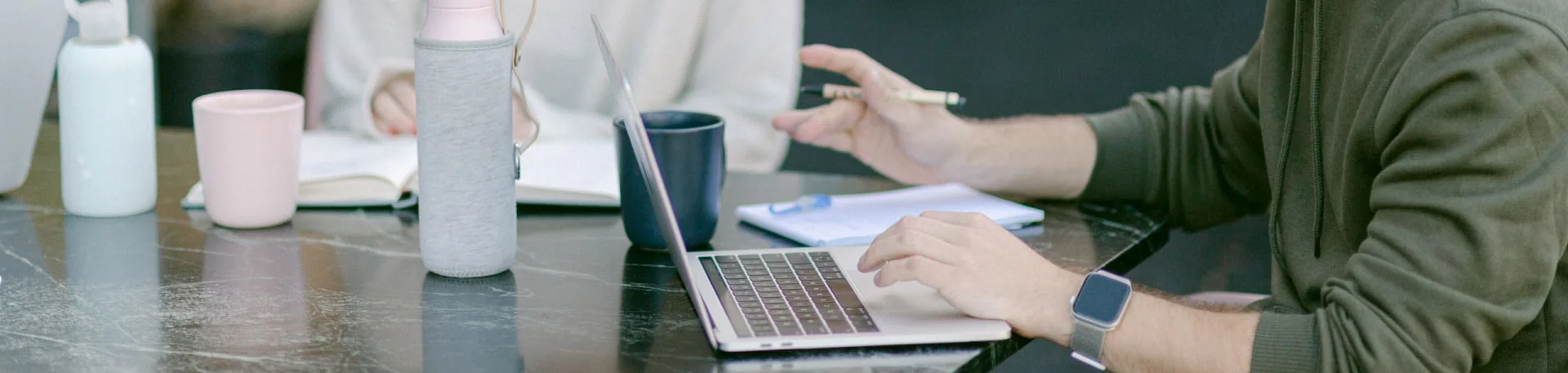Corporate workspace — laptops on a shared desk